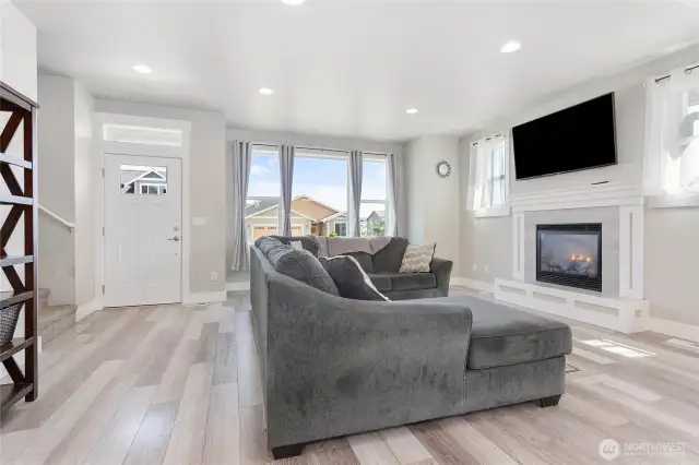 Living room features tall ceilings and lots of windows for the sunshine to pour in.