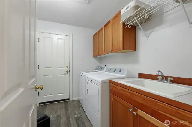 Large laundry/mudroom with new vinyl plank flooring & ample storage