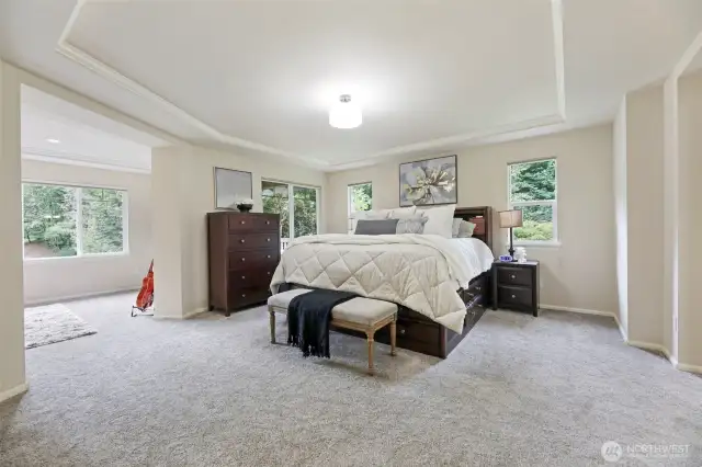 Luxurious primary suite with French doors, sitting room, and private covered deck