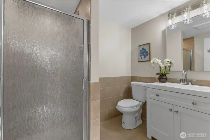 Freshly tiled second bath featuring a walk-in shower and contemporary finishes.