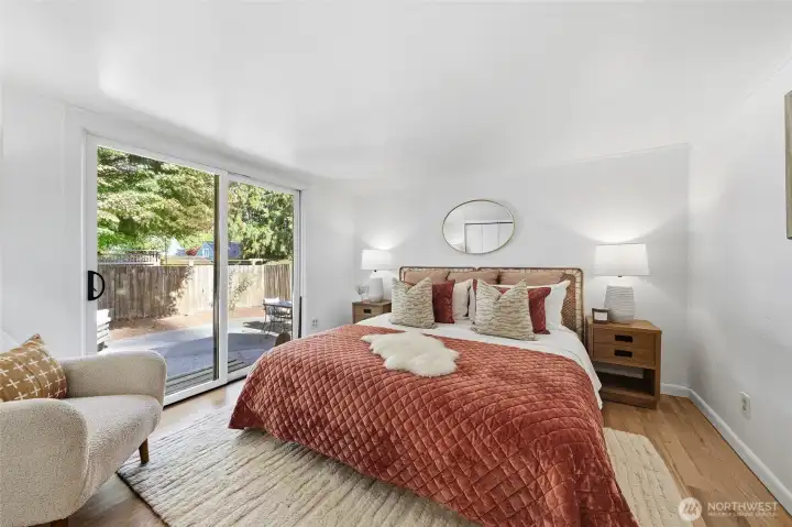 Primary bedroom with sliding glass doors heading to the backyard