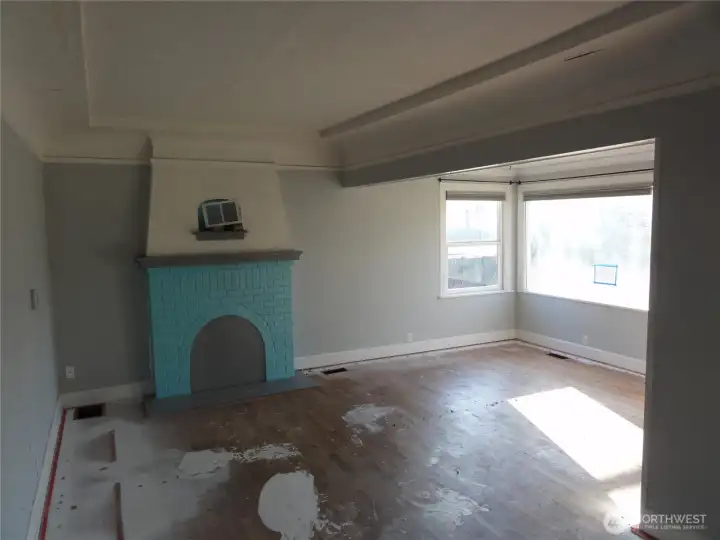 Living room with fireplace and dining area.