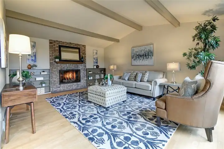 Cozy up by the gas fireplace with brick surround and bookcases
