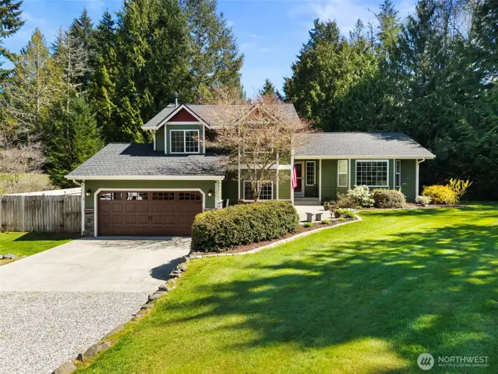 First time on the market! Set on a shy acre, this beautifully maintained home welcomes you with an expansive driveway, lush lawn, and classic Northwest charm.