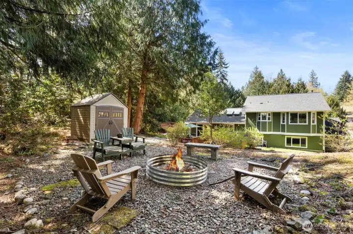 Explore the terraced yard with steps leading to upper grounds, offering usable outdoor space and a natural, Northwest setting.