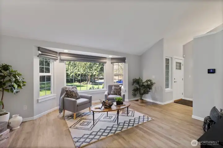 Open and airy living space designed for comfort and everyday living. New motorized shades in the living room offer effortless light control at the touch of a button, adding both convenience and a refined, modern feel.