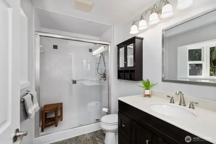 Freshly updated with clean finishes, the  primary bathroom features a walk-in shower designed.