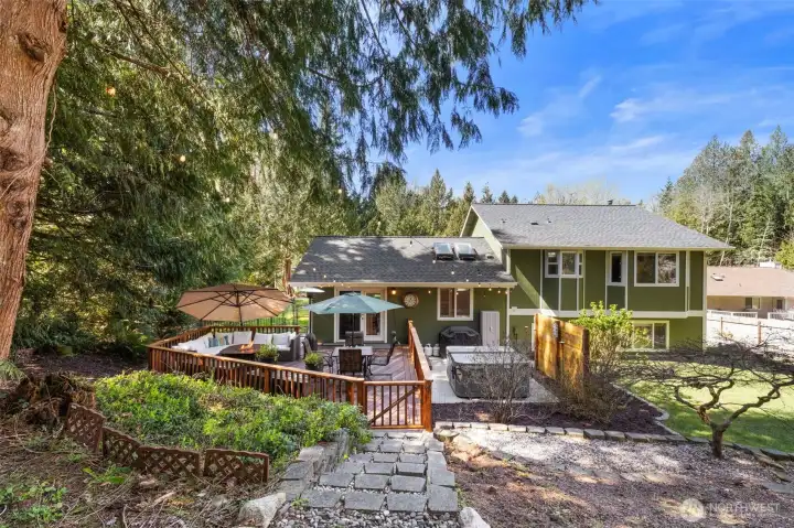 Tastefully terraced and manicured landscaping, complete with raised beds on the north side of the home, ideal for garden enthusiasts.