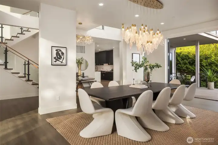 Sunlit dining space seamlessly connected to the kitchen and terrace, blending indoor elegance with effortless outdoor living