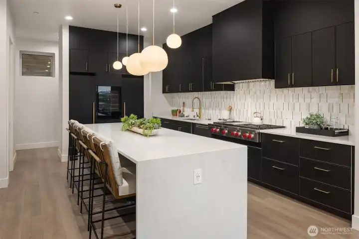 Streamlined elegance meets high performance with a Miele fridge/freezer and built-in wine fridge, perfectly integrated into this chef's kitchen