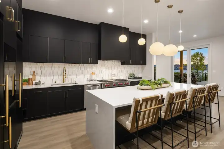 Cook and entertain with inspiring lake views, framed by the kitchen's sleek design and expansive sliding doors