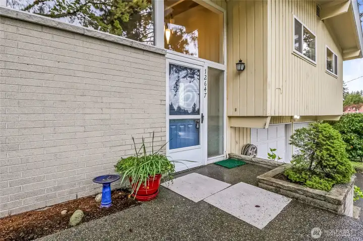 Welcoming front door entry with charming courtyard appeal.