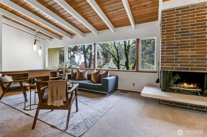 Welcoming upstairs offers hardwood plank vaulted ceilings, in the sunny living & dining room with a cozy fireplace.