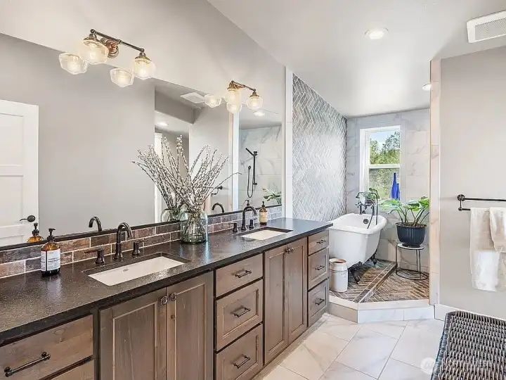 Master bath with dual sinks, granite counter top, and tile floor.