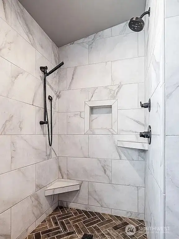 Custom tile shower with dual selectable shower heads.