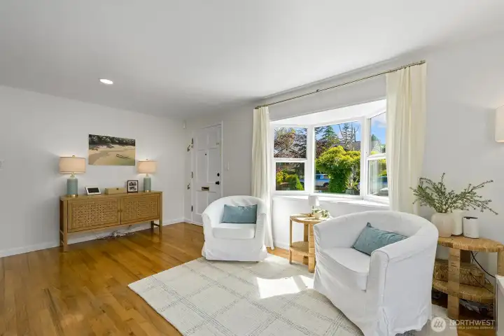 A close up of the living room area showing the entry and the bay window on the front of the house.