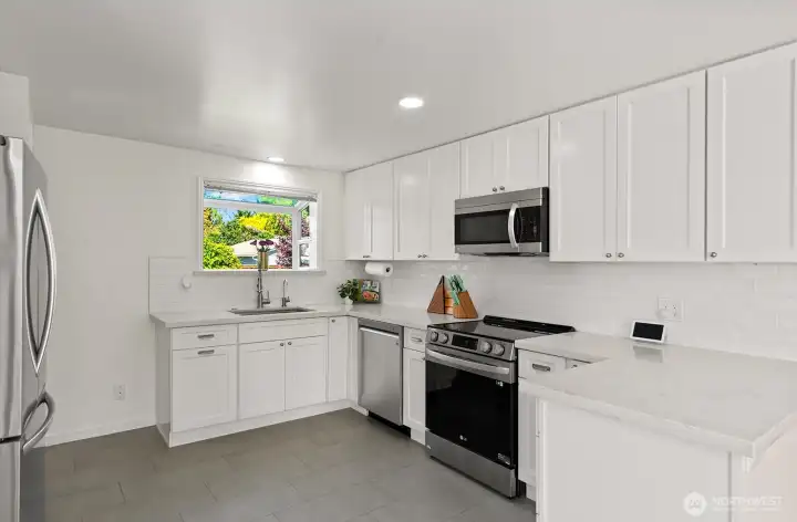 Another view of the kitchen showing the sink and garden window.