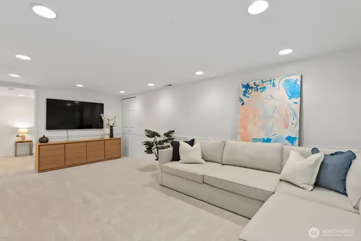When you go downstairs you enter into a spacious family room .