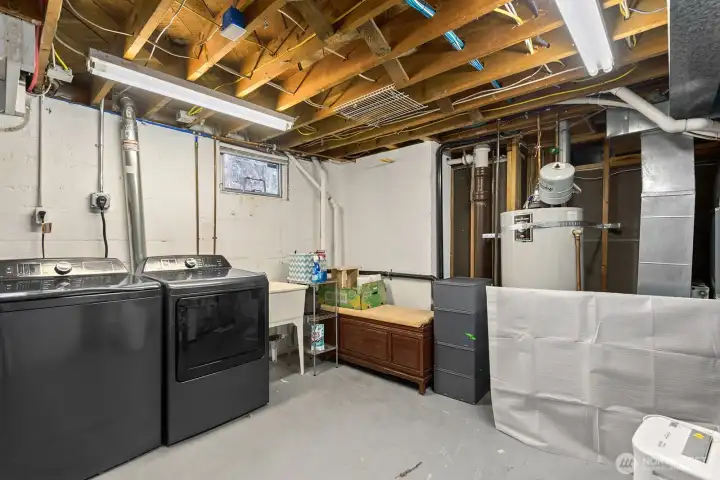 There's a good-sized laundry and utility room with plenty of room for storage (there's a shelf unit on the wall to the right, not pictured).  Newer gas furnace and A/C!