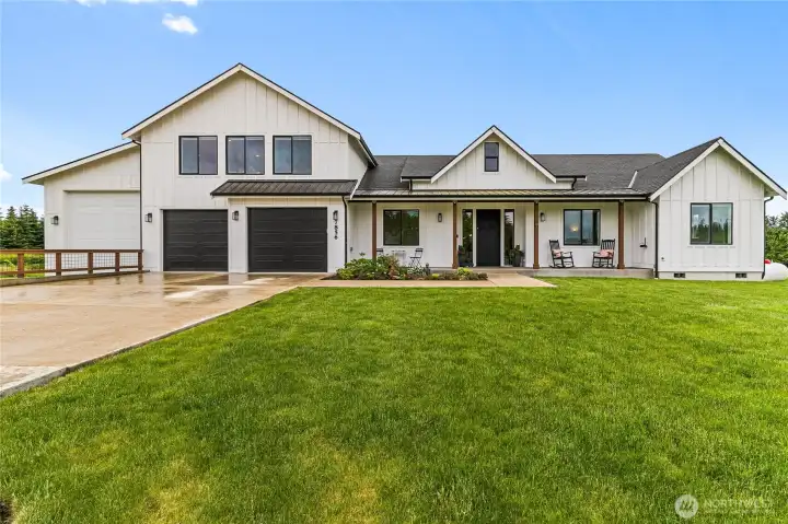 Front elevation. 30yr Pebco composite roofing with Metal accents really boost the Modern Farmhouse style. The attached 16X45 ft RV garage/shop to the left is a stand-out addition to this custom home.