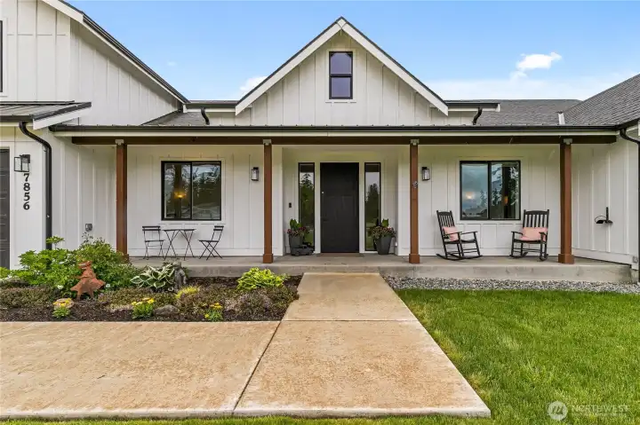 This inviting country front porch creates a warm and stylish welcome for every guest who arrives.