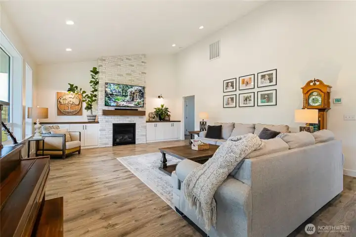 This spacious living room offers plenty of room to gather, with the gas fireplace and custom built-ins serving as the inviting centerpiece.