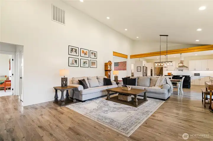 Another view of the living room showcases the seamless flow into the dining area and kitchen. To the left, you’ll find two additional bedrooms and a full bathroom tucked away on this side of the home.