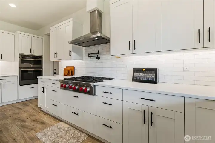 Any home chef will appreciate cooking in this well-appointed kitchen, featuring a 36” Wolf range and convenient pot filler. Abundant counter space and generous storage make this a true culinary dream.