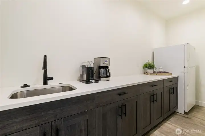 The spacious walk-in pantry off the kitchen offers abundant cabinetry, a prep sink with disposal, and even an additional refrigerator. There is also potential for upper cabinetry, which the sellers had planned but did not install.
