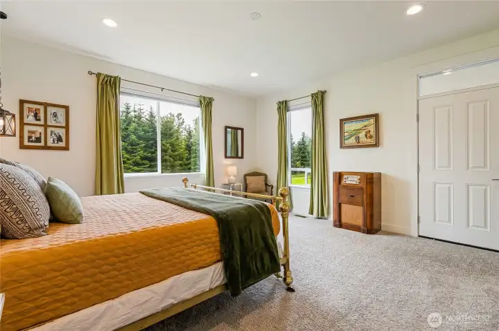 Primary bedroom with view of door leading to back deck.