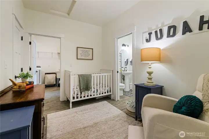 This is actually a mudroom that is large enough to be used as an additional bedroom. Straight ahead is the laundry room, and to the right is a powder room that even includes a urinal! The closed door to the left is a closet that is large enough to be an extra play/reading area for your littles!
