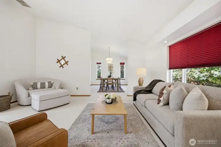 Looking across the living room toward the dining room which both look onto the rear yard.