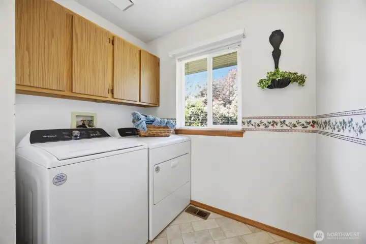 The laundry room is just off the family room and has good cabinet storage, as well.