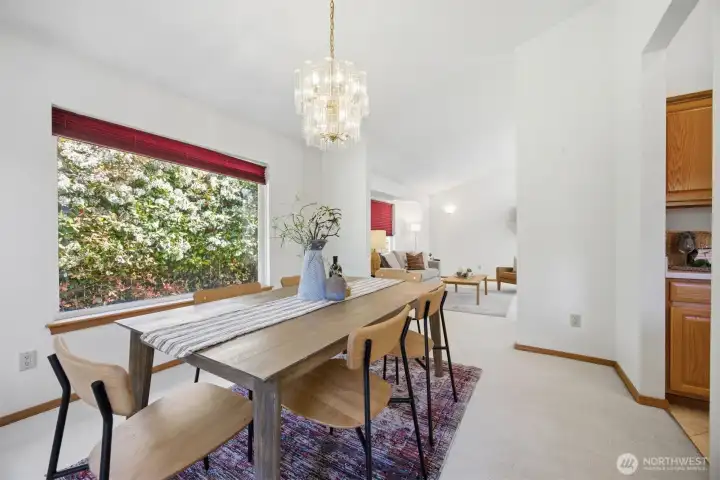 The dining room is between the kitchen and the living room and has vaulted ceilings.