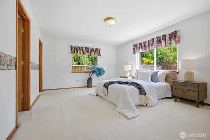 The primary suite is at the far end of the home and is very spacious.