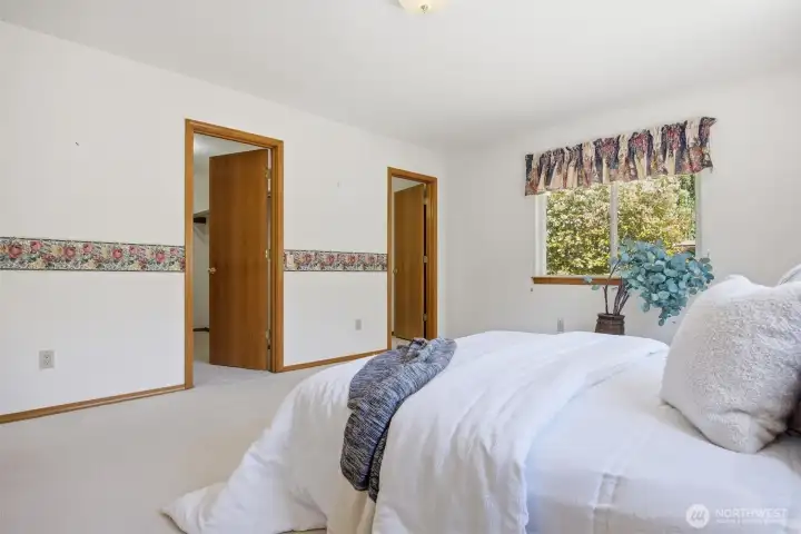 There is a large walk-in closet and spacious spa-like bath off the primary bedroom which takes in the rear and south side yard views.