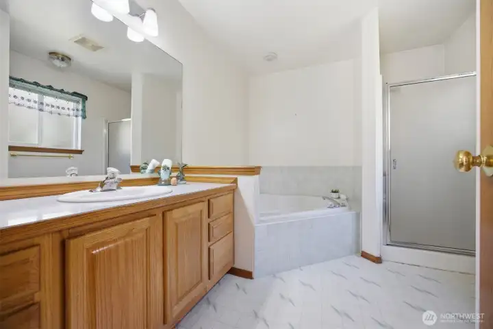 The spa-like bath has a large jetted soaking tub and separate shower.