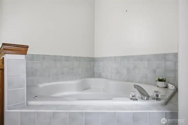 The corner soaking tub is quite lovely.