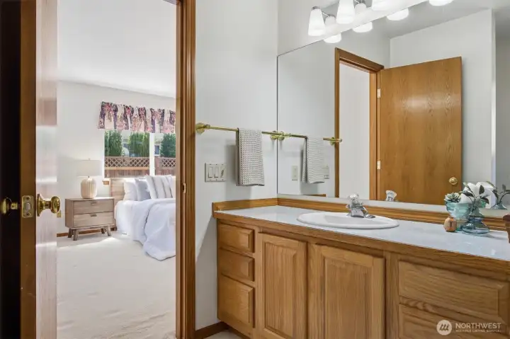Looking from the primary bath vanity to the bedroom.