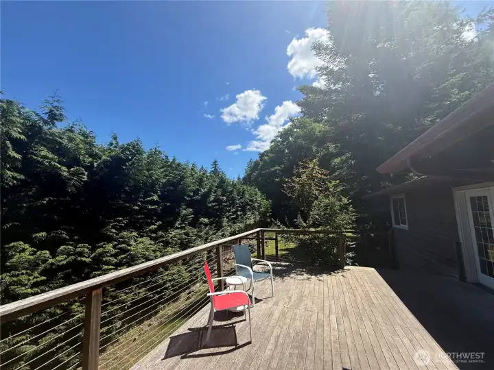 Sunny hardwood deck space just off great room and primary bedroom Sunny hardwood deck space just off great room and primary bedroom