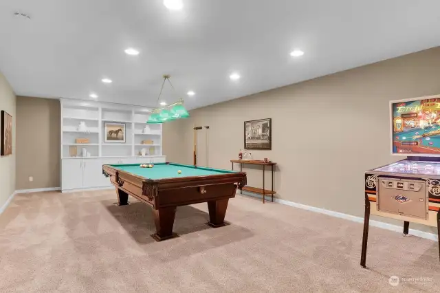 Just off the family is another amazing bonus room! This fabulous pool table can stay for the new owner for hours of fun. The custom built cabinet offers storage and plenty of shelving for displaying collectables and treasures.