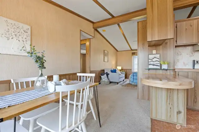 Looking from the dining room toward the living room with the vaulted ceilings and openness.