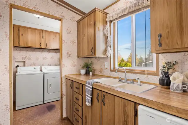 The views from the sink are amazing and the laundry room is adjacent with a back door and pantry storage.