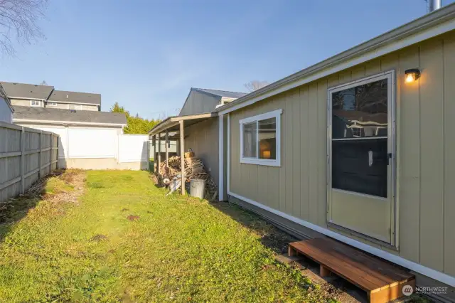 Looking at the rear of the home with the wood storage off the shop and so easily brought into the living room through the back door.