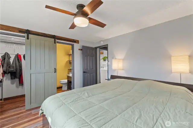 The barn door slides to cover either the half bath or the walk in closet.