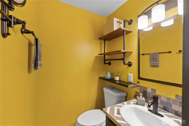The compact primary half bath has rustic fixtures.