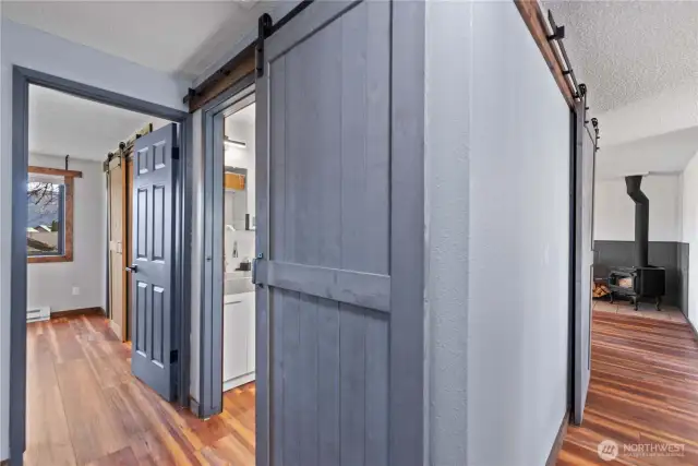 This hallway barn door provides privacy for the full bath without taking up space that a swinging door would require.