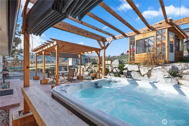 Here we are on the patio level. The hot tub, included in the sale, has its own arbor with sliding cover.  Note the greenhouse on the upper terrace.