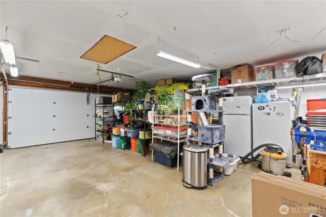 This is a true 2 car garage.  Bring your own EV hookup to plug into the outlet already in place.