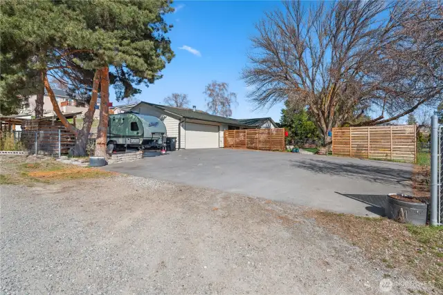 This property has so much parking!  2 cars in the garage, an RV (with 30 amp hookup) tucked next to the garage, and a big paved parking area to accommodate many other vehicles.